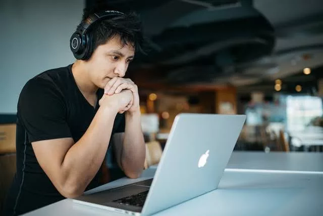 A man looking at his laptop