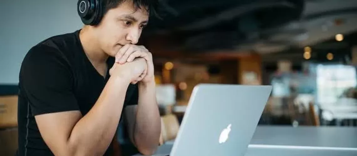 A man looking at his laptop
